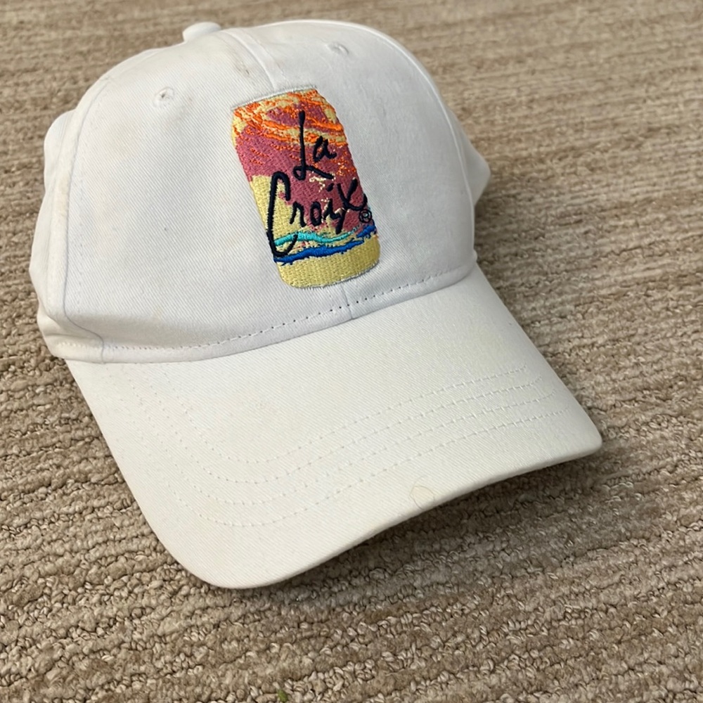 LaCroix white hat. Velcro back. Slight discoloration